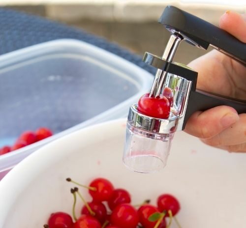Cherry pitter tool removing pits from cherries that are not seedless/pitless