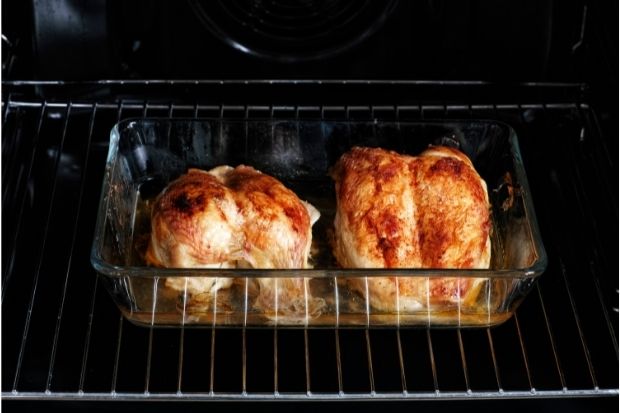A glass oven tray full of chicken that can be put in the oven