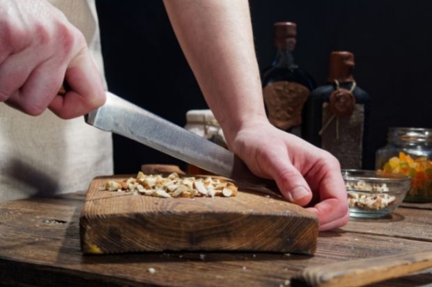 Chef using knife to chop nuts instead of blender