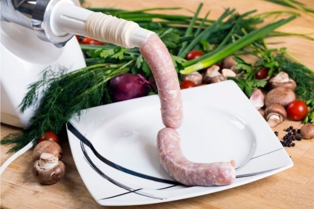 Sausage stuffer making sausages after chef researched sausage stuffer vs grinder