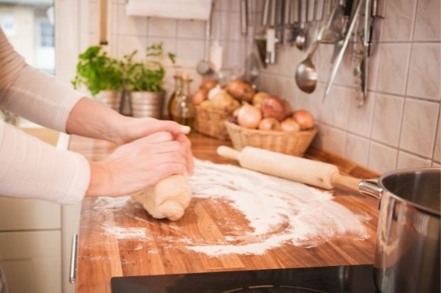 Person kneading dough on the best surface for kneading dough