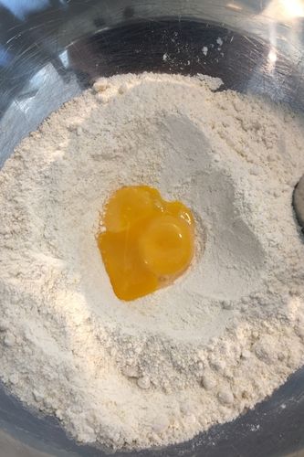 Heart-shaped egg yolk in flour