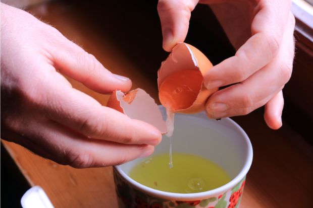 Separating egg yolk over cup instead of using whole egg in pudding