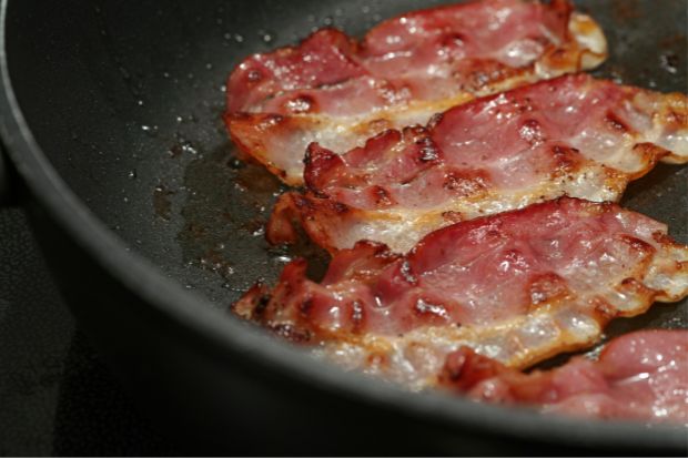 Bacon frying in pan after chef learned if you need to oil the pan for bacon