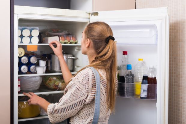 Woman sorting through fridge to store sausage casings so they won't go bad