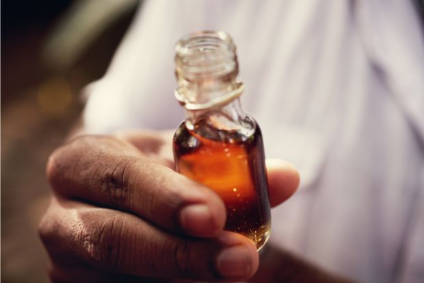 Person holding vanilla extract that tastes different from clear vanilla