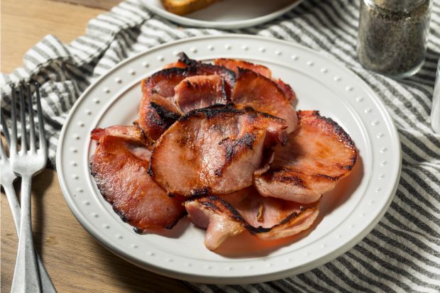 Plate of Canadian bacon that isn't as salty is regular bacon