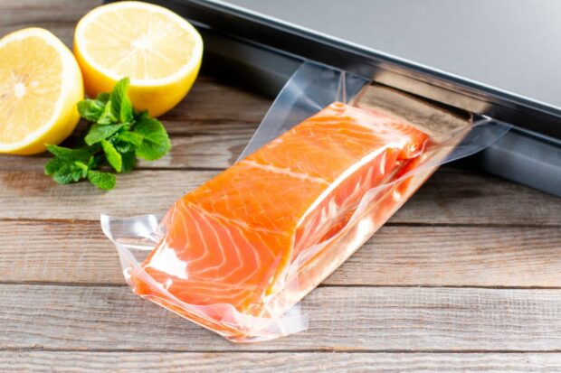 Salmon fillets being vacuum sealed for sous vide cooking