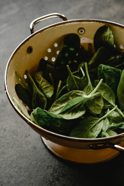 Draining spinach in a colander