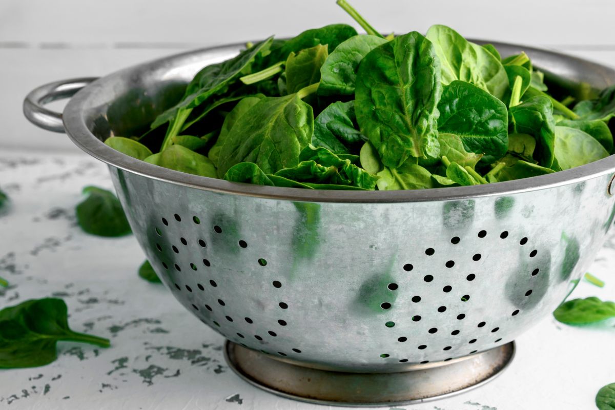 Draining spinach in a colander