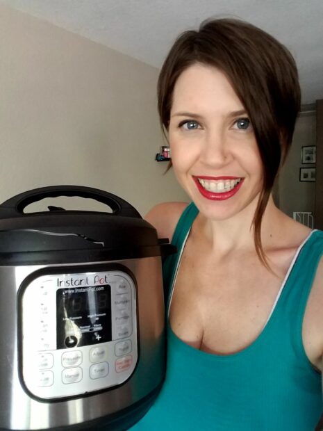 Woman holding Instant Pot that can be used to steam buns without a steamer